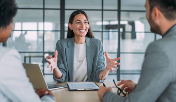 Shot of group of business persons in business meeting. Three entrepreneurs on meeting in board room. Corporate business team on meeting in modern office. Female manager discussing new project with her colleagues. Company owner on a meeting with two of her employees in her office.